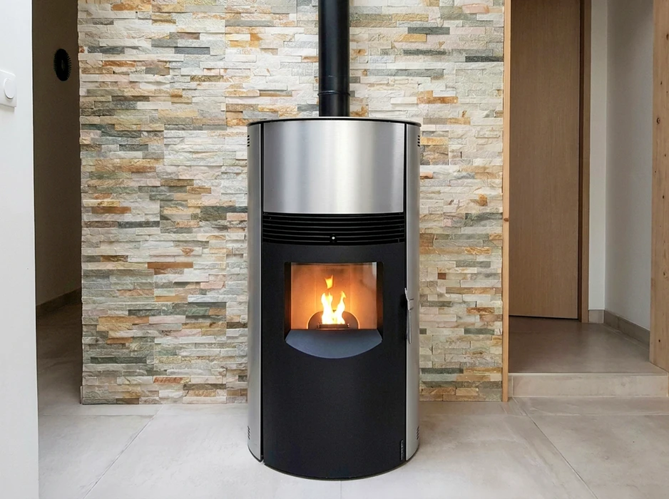 Poêle à granulés cylindrique moderne, design bicolore noir et inox brossé, vitre de combustion rectangulaire avec flammes vives visibles, conduit d'évacuation noir vertical